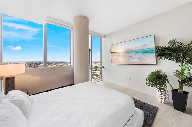 a bedroom with a large bed and a night stand