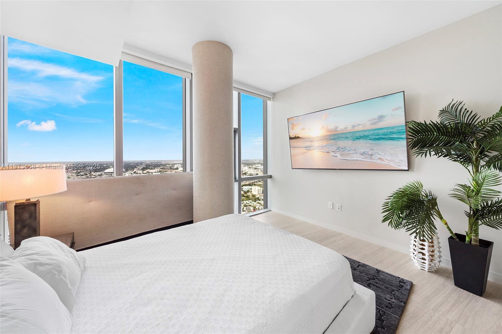 851 Northeast 1st Avenue, Unit 5312 Miami, FL 33132 - Photo 36 of 53 a bedroom with a large bed and a potted plant