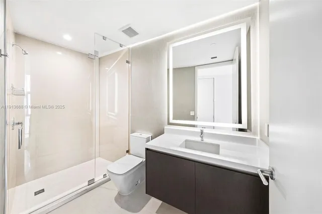 a bedroom with a large bed and a large window