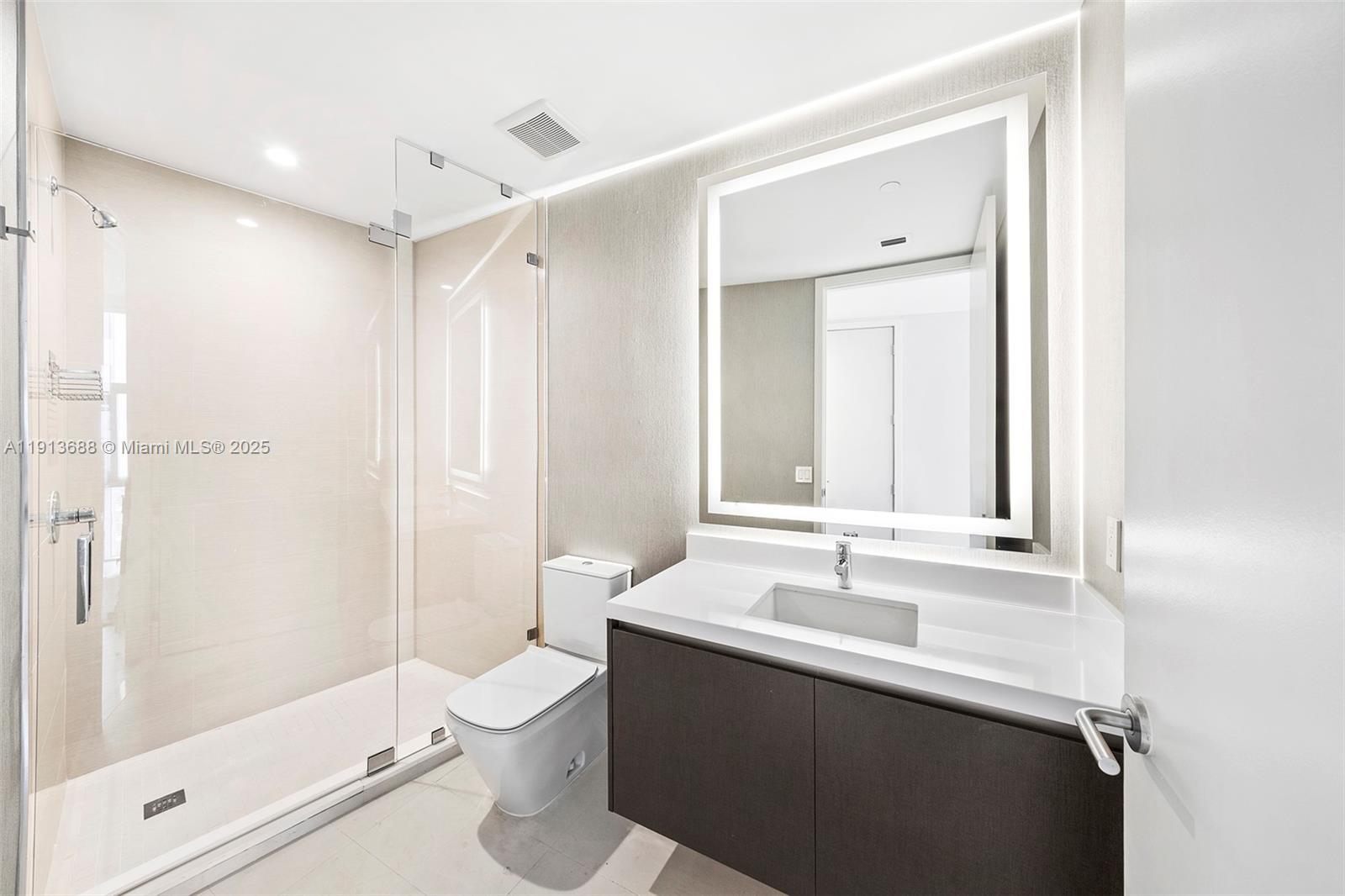 851 Northeast 1st Avenue, Unit 5312 Miami, FL 33132 - Photo 37 of 53 a bathroom with a sink a toilet and shower