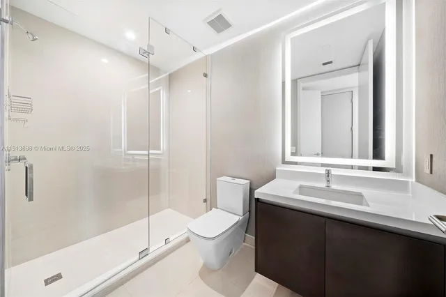 a bedroom with a bed and large window