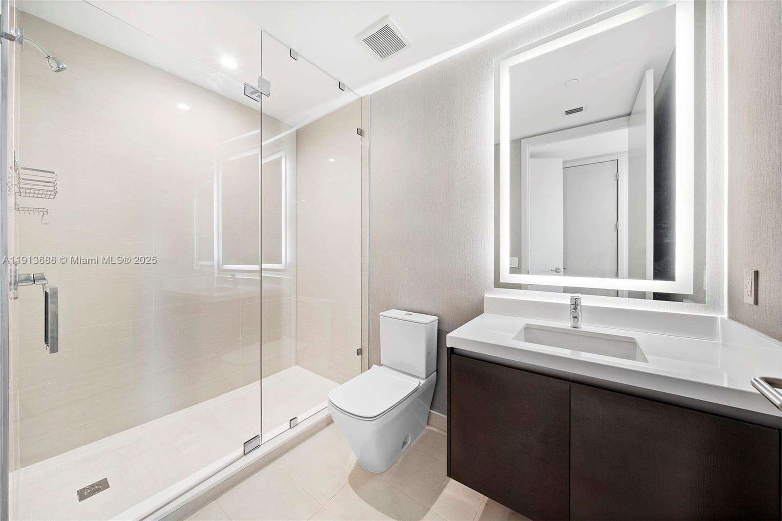 851 Northeast 1st Avenue, Unit 5312 Miami, FL 33132 - Photo 41 of 53 a bathroom with a sink a toilet and shower