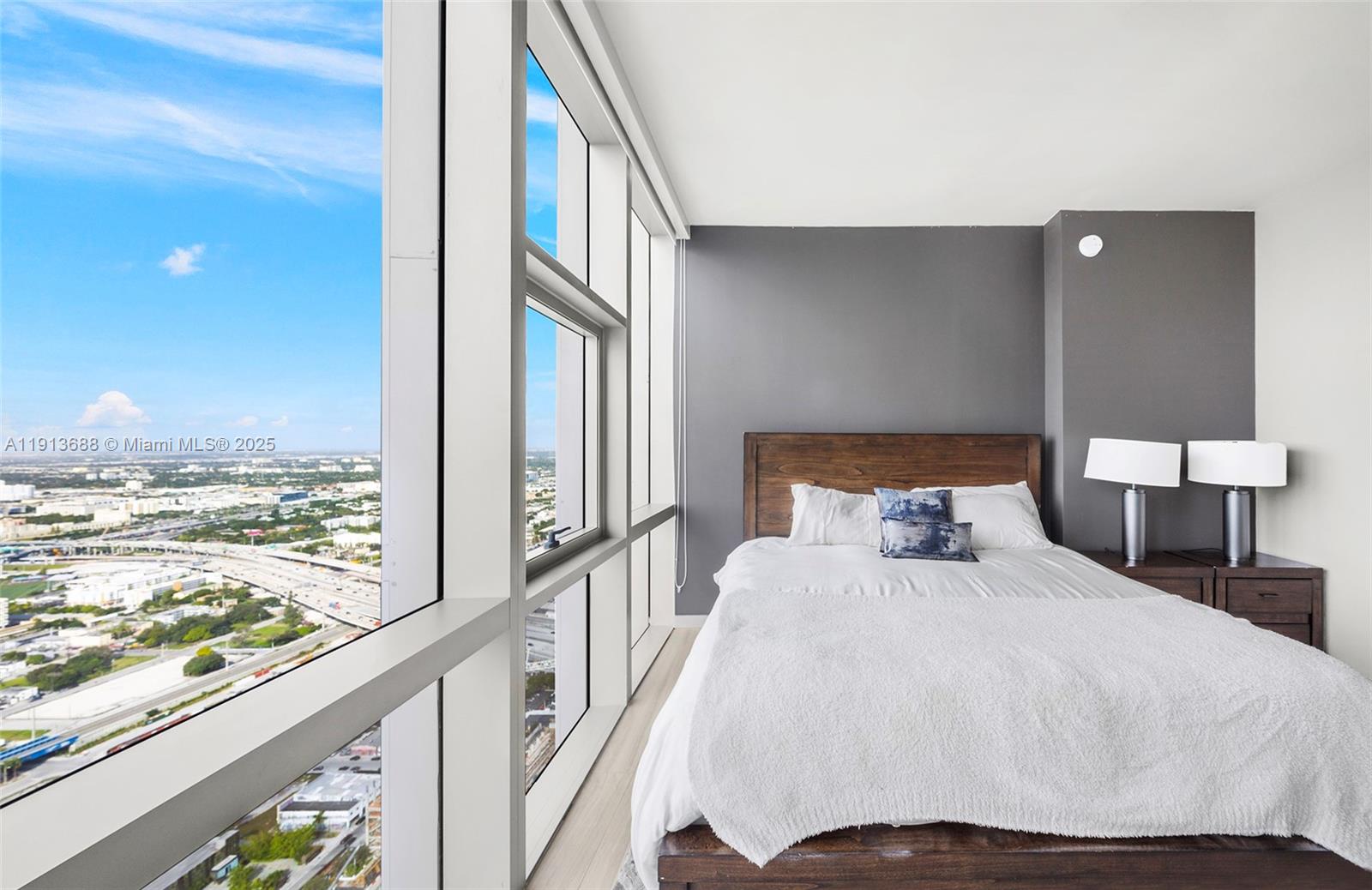 851 Northeast 1st Avenue, Unit 5312 Miami, FL 33132 - Photo 44 of 53 a bedroom with a bed and a large window