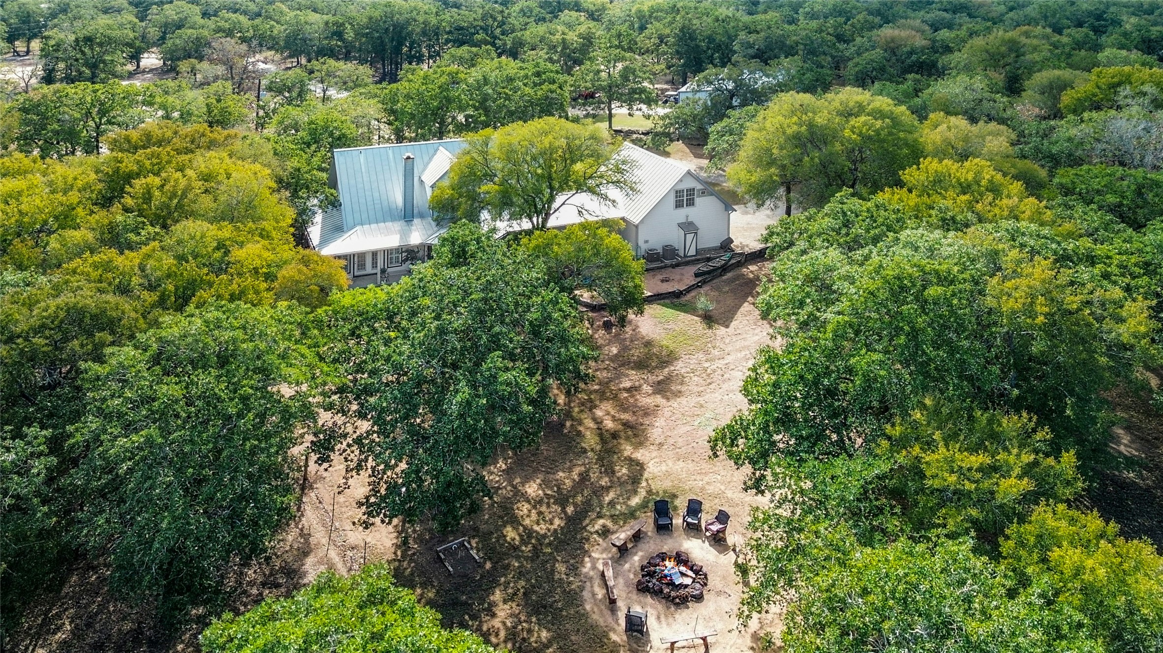 412 Woody Hollow Road Luling, TX 78648 - Photo 7 of 33 Aerial view of property and surrounding area with fire pit and mature trees