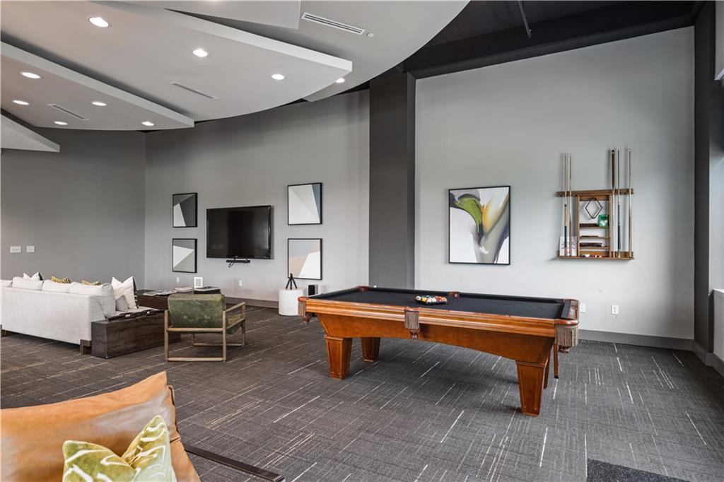 250 Pharr Road Northeast, Unit 606 Atlanta, GA 30305 - Photo 20 of 31 a living room with furniture and a flat screen tv