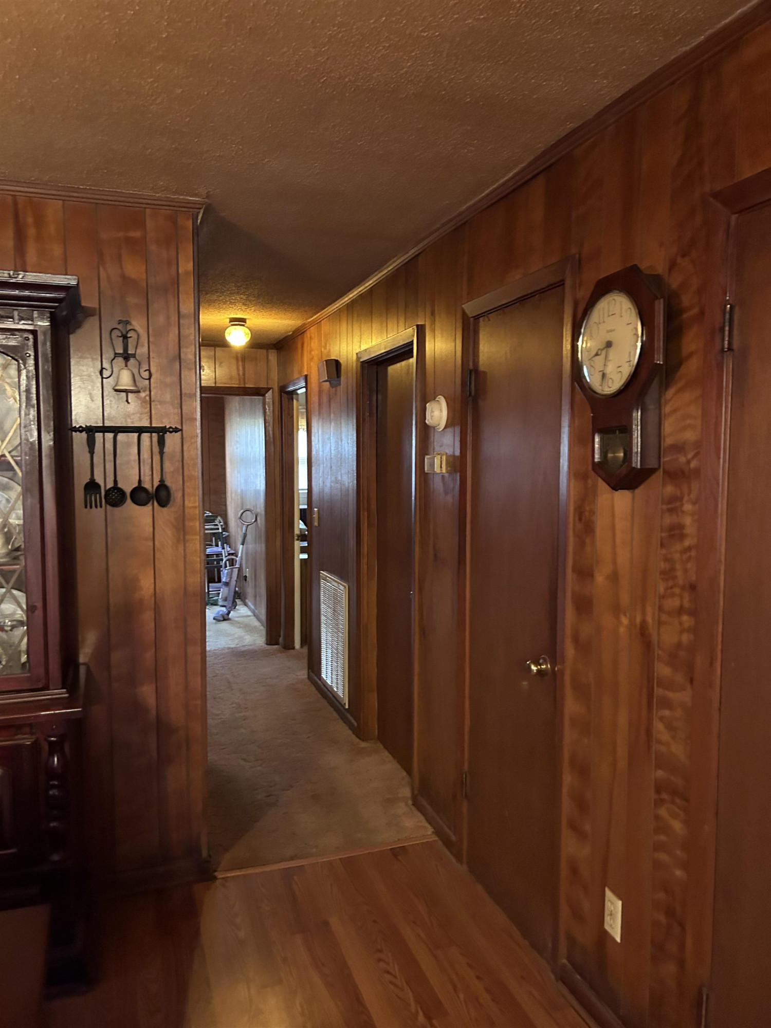 4145 Swannie Coble Road Snow Camp, NC 27349 - Photo 7 of 11 a view of a hallway with stainless steel appliances a refrigerator and wooden floor