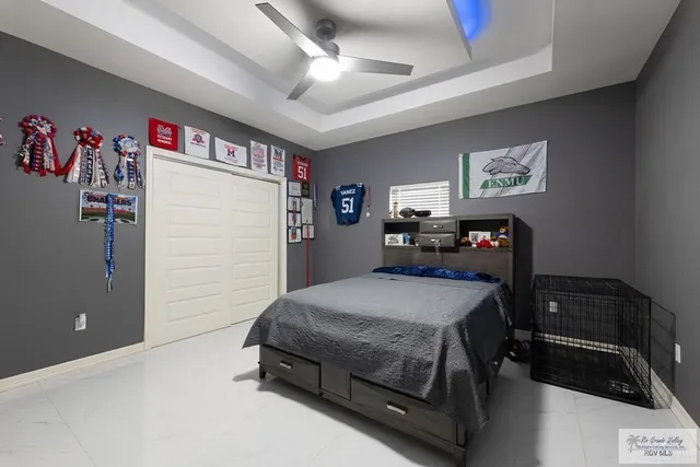 a bedroom with a bed and a refrigerator