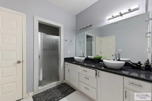 a kitchen with granite countertop a sink and cabinets