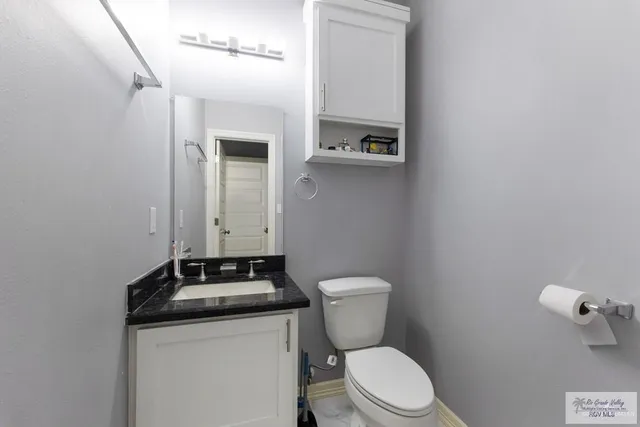 a bathroom with a sink a toilet and mirror