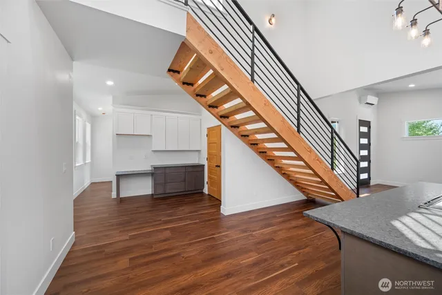 a view of entryway and hall with wooden floor