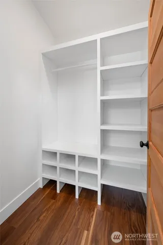 a view of walk in closet with empty racks