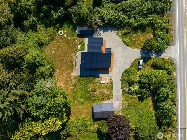 an aerial view of a house with a yard