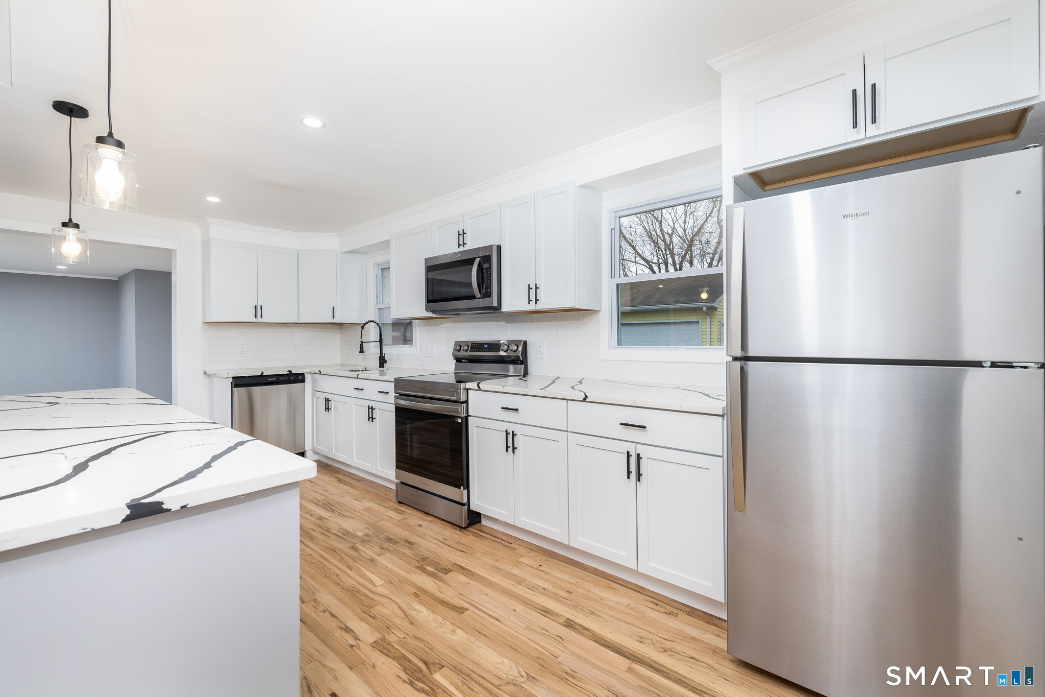 555 Graham Road South Windsor, CT 06074 - Photo 16 of 39 a kitchen with white cabinets and stainless steel appliances
