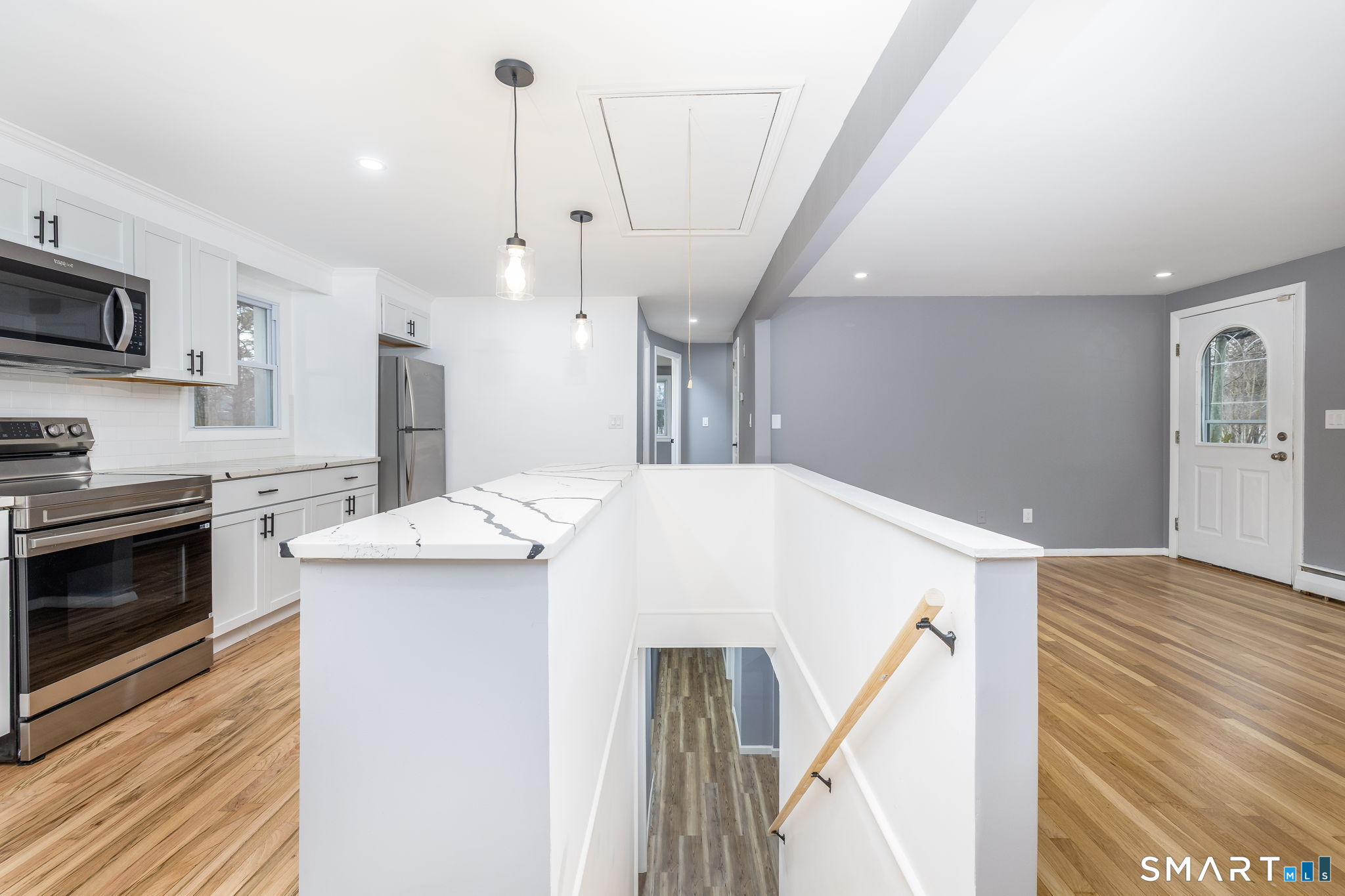 555 Graham Road South Windsor, CT 06074 - Photo 21 of 39 a kitchen with stainless steel appliances kitchen island a white stove top oven and wooden floor