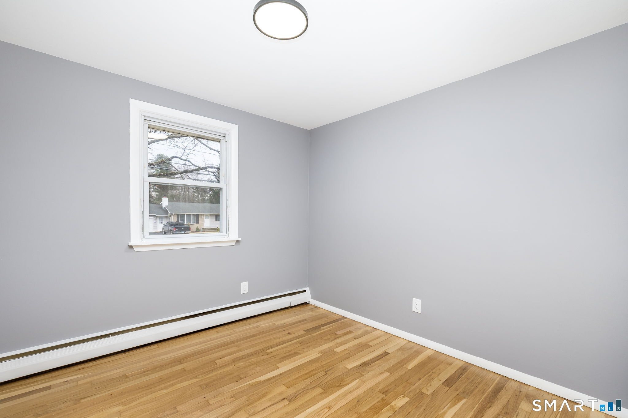 555 Graham Road South Windsor, CT 06074 - Photo 23 of 39 a view of an empty room with wooden floor and a window