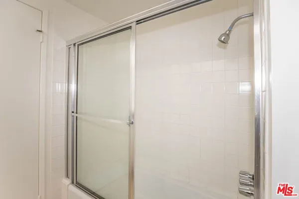 a bathroom with a glass shower door
