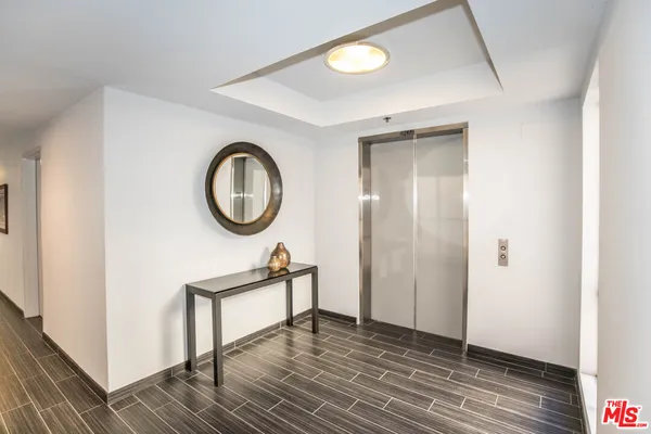 a view of a room with wooden floor and a sink