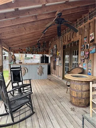 a view of a roof deck with table and chairs
