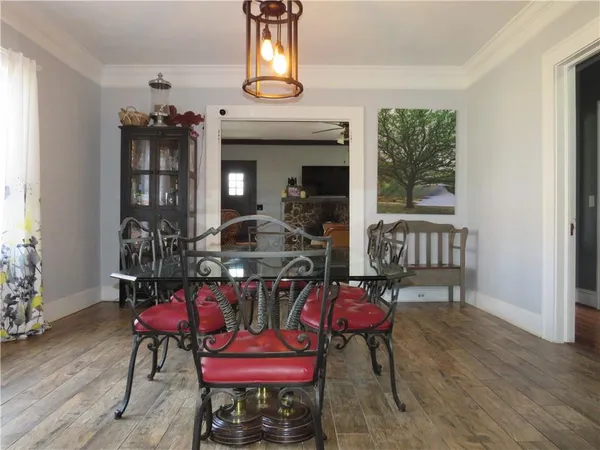 a view of a dining room with furniture and chandelier