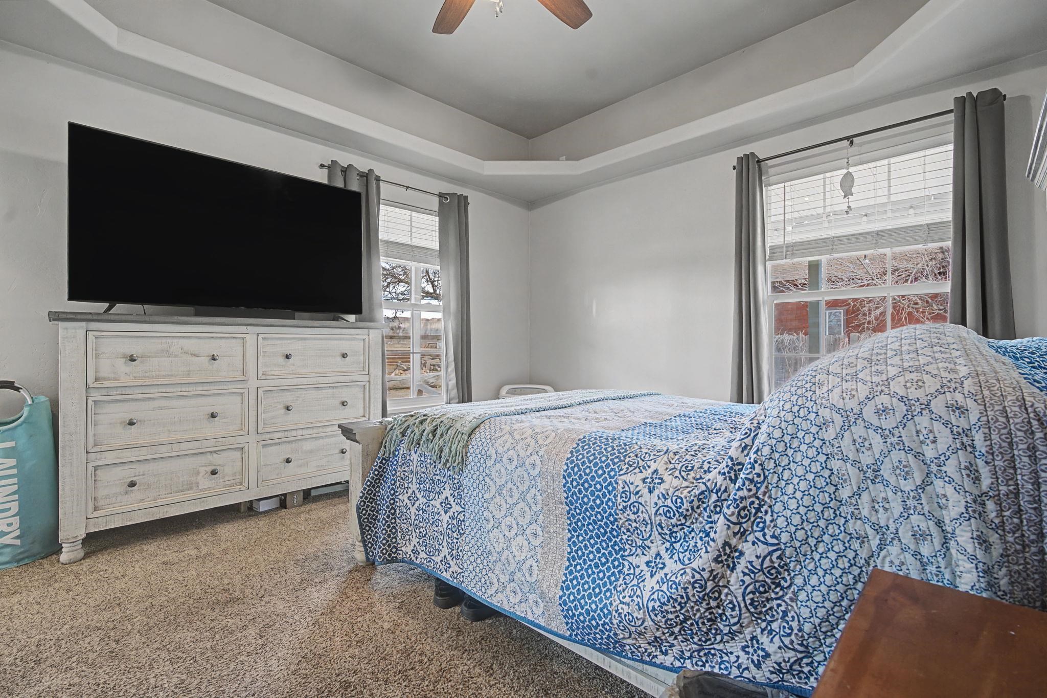 3055 E Road Grand Junction, CO 81504 - Photo 14 of 32 a bed room with a flat screen tv and a dresser