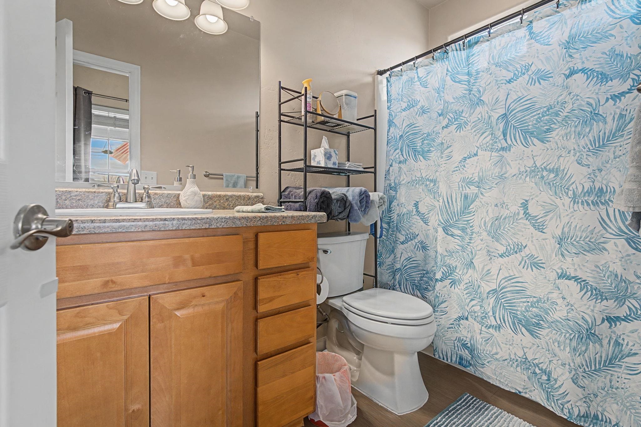 3055 E Road Grand Junction, CO 81504 - Photo 16 of 32 a bathroom with a sink toilet and mirror