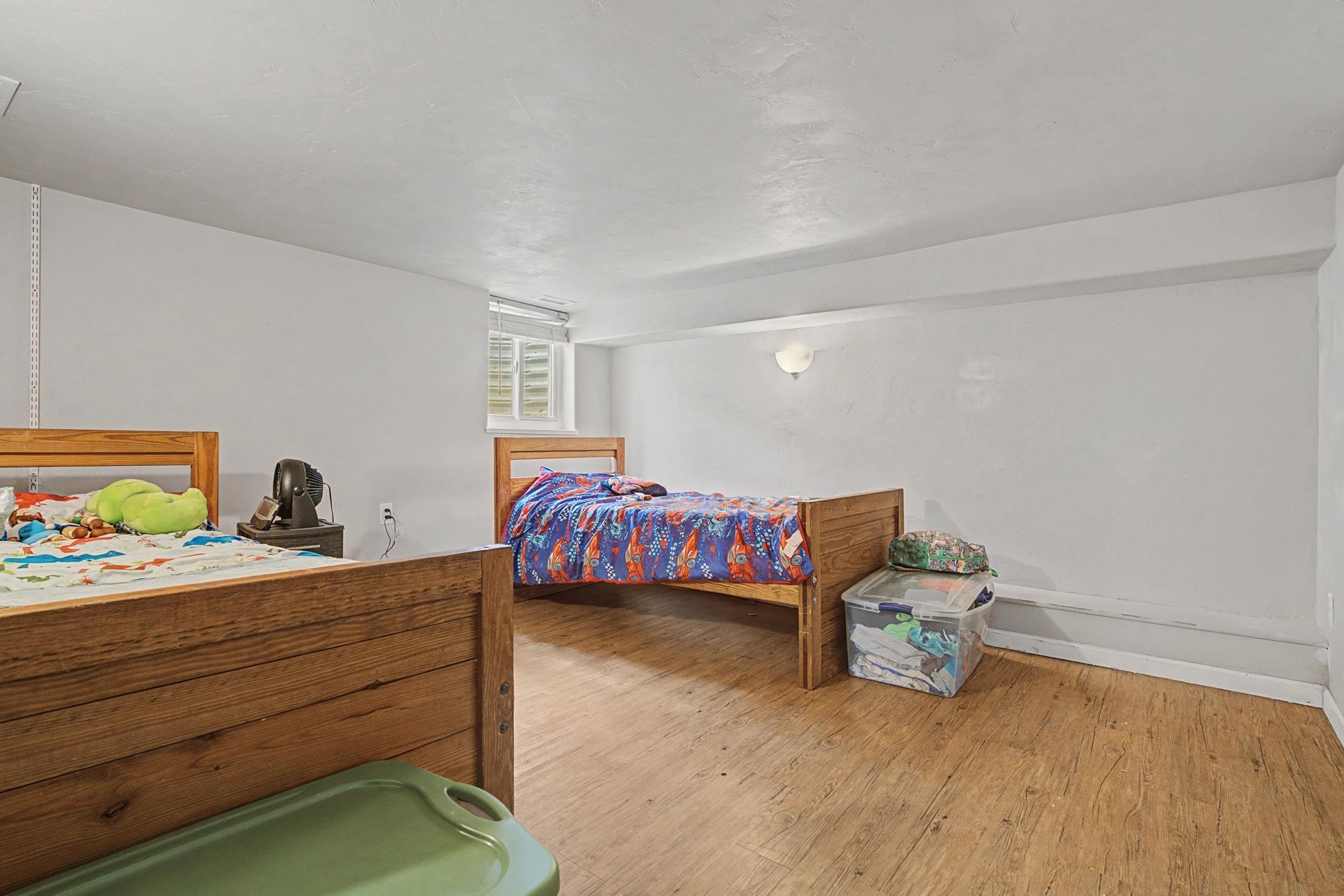 3055 E Road Grand Junction, CO 81504 - Photo 19 of 32 a bedroom with a bed and a window