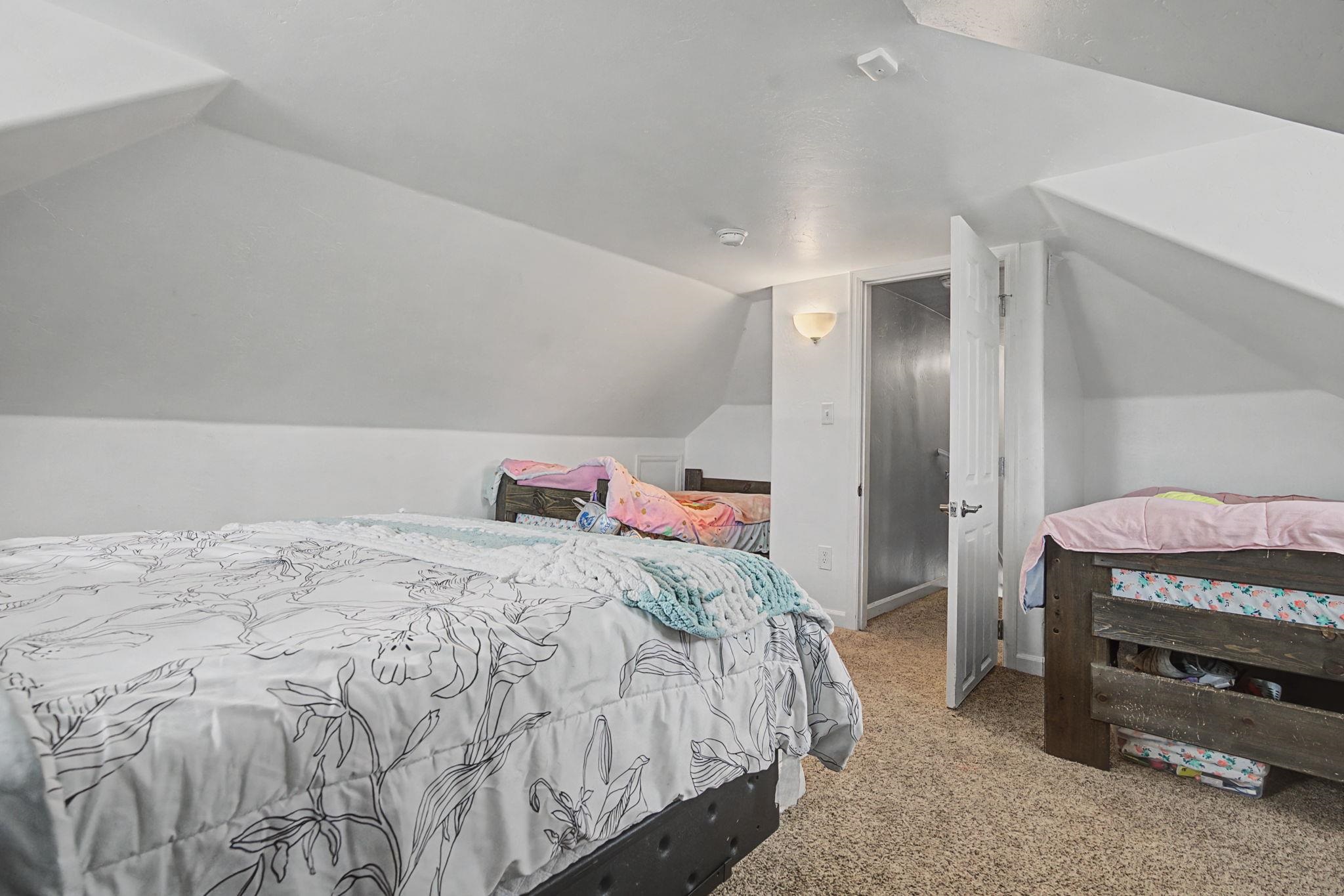 3055 E Road Grand Junction, CO 81504 - Photo 22 of 32 a bedroom with a bed and a window