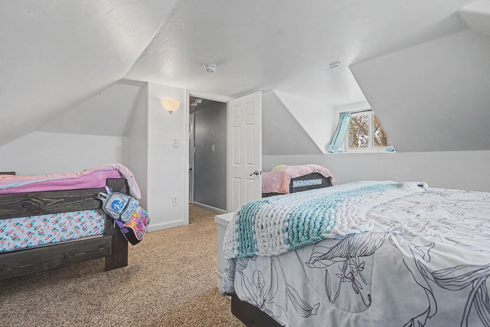 3055 E Road Grand Junction, CO 81504 - Photo 23 of 32 a bedroom with a bed and a window