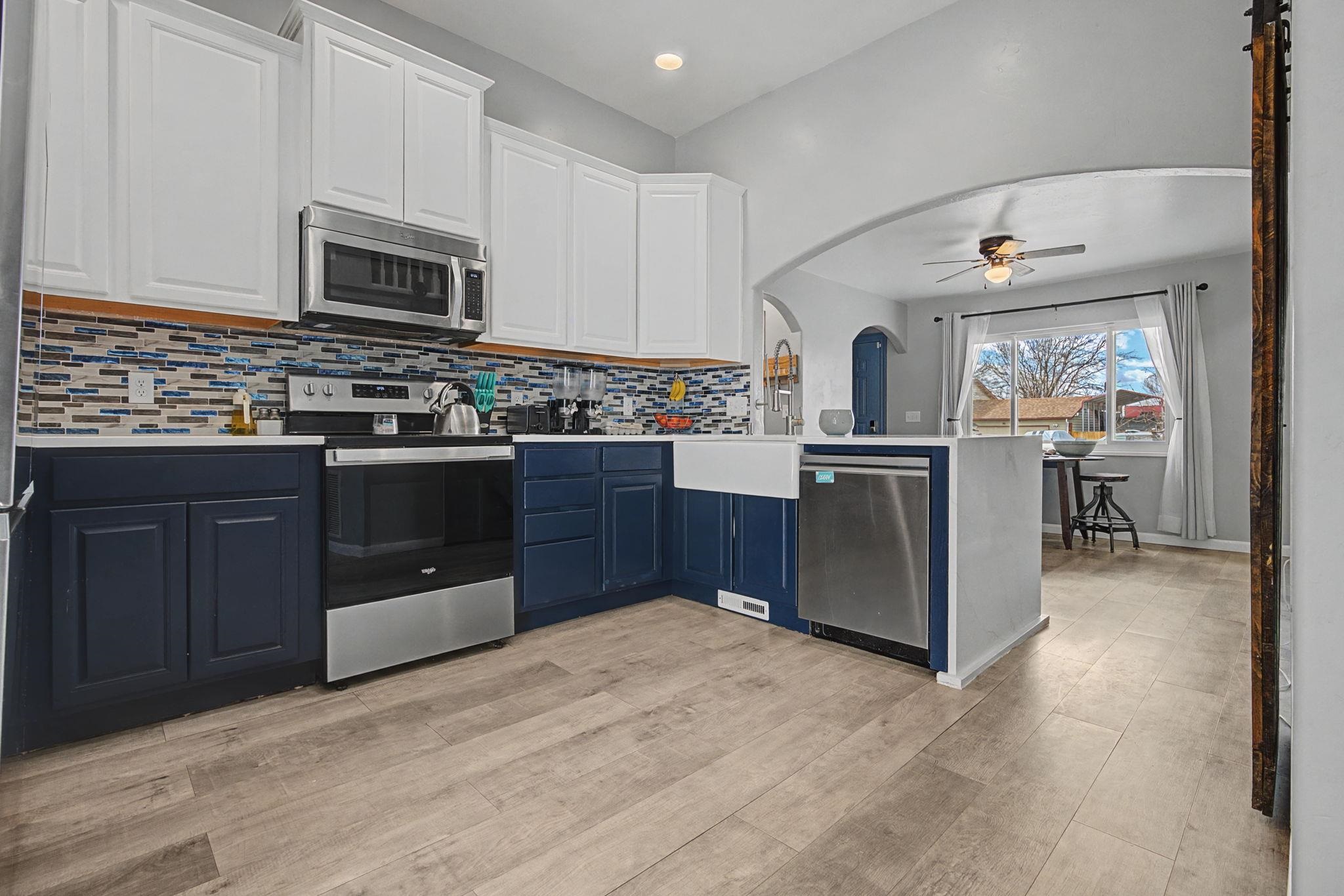 3055 E Road Grand Junction, CO 81504 - Photo 5 of 32 a kitchen with stainless steel appliances granite countertop a stove cabinets and refrigerator