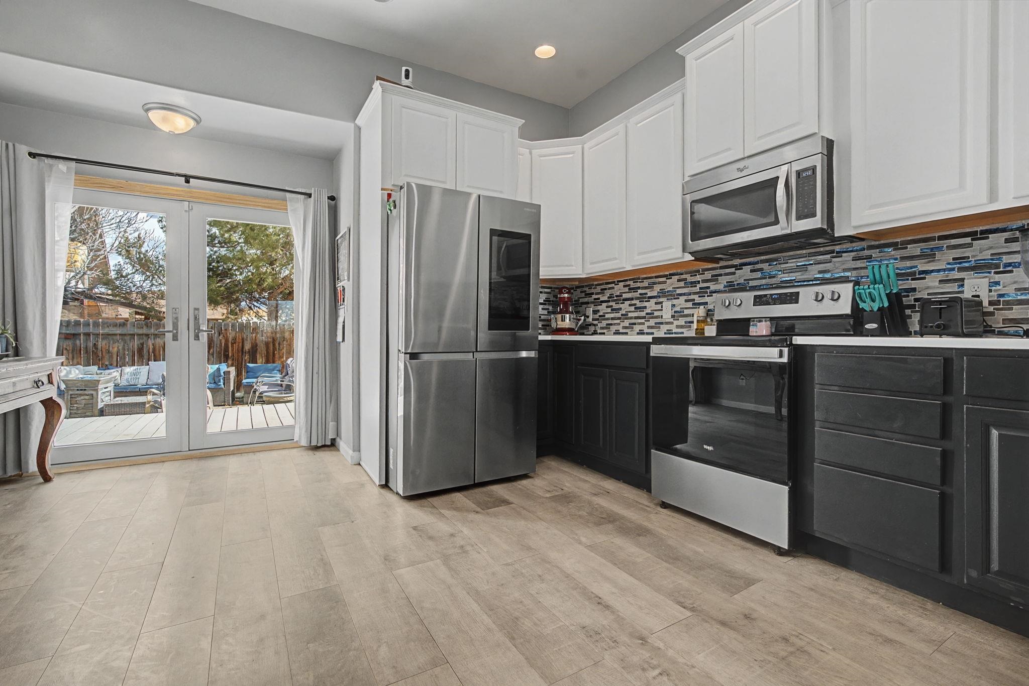 3055 E Road Grand Junction, CO 81504 - Photo 7 of 32 a kitchen with stainless steel appliances granite countertop a refrigerator and a stove top oven