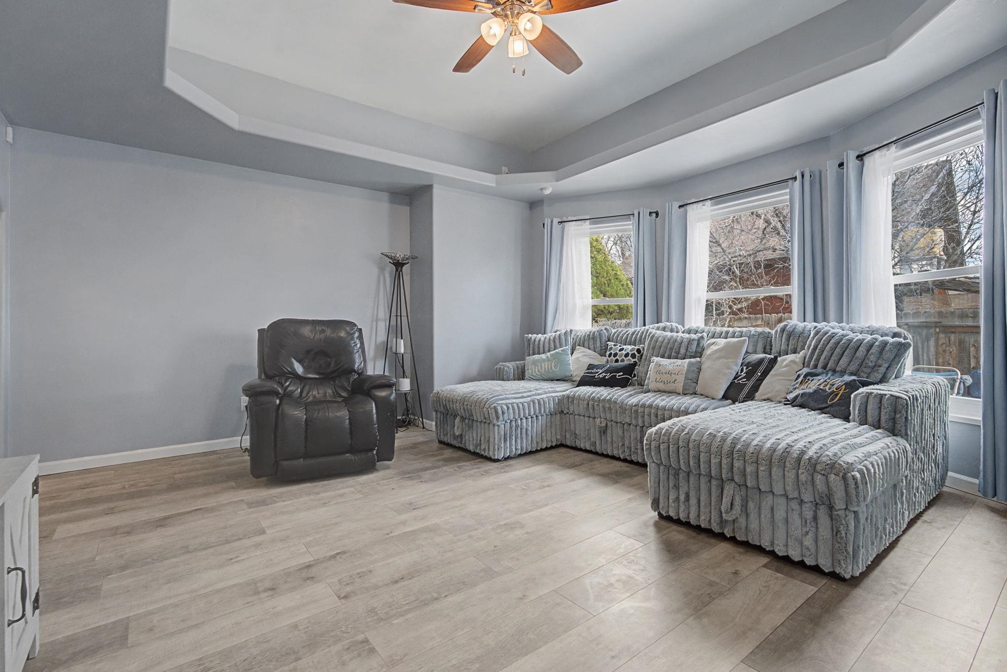 3055 E Road Grand Junction, CO 81504 - Photo 8 of 32 a living room with furniture ceiling fan and a window