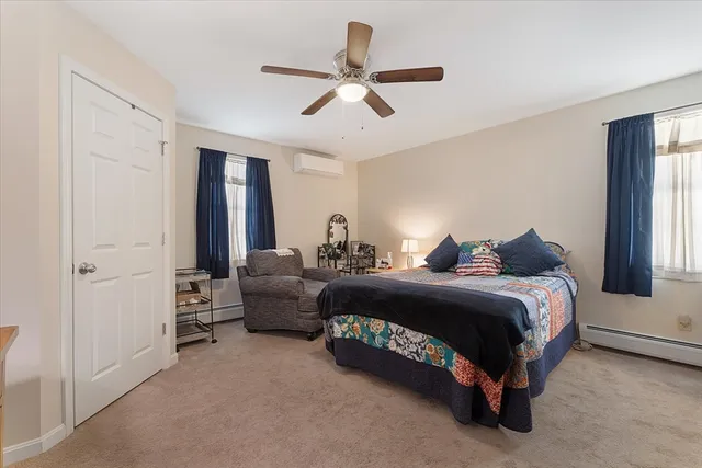 a spacious bedroom with a bed and window