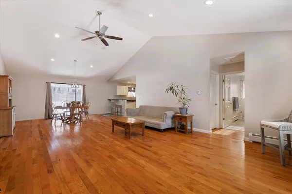 a living room with furniture and a wooden floor