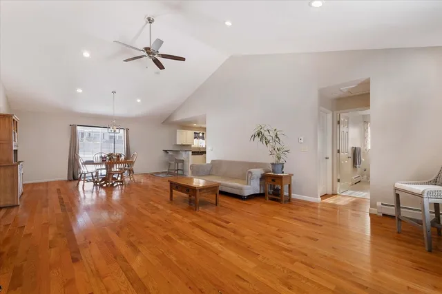 a living room with furniture and a wooden floor