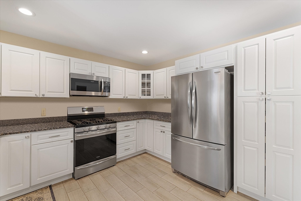 77 Old Keene Road Athol, MA 01331 - Photo 9 of 31 a kitchen with cabinets stainless steel appliances and wooden floor