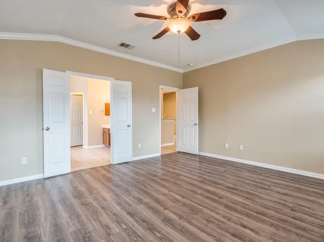 a spacious bathroom with a double vanity sink and a mirror