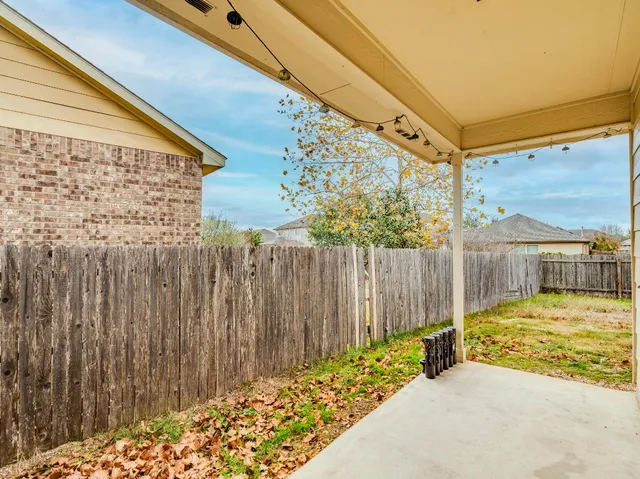 a view of a house with a wooden fence