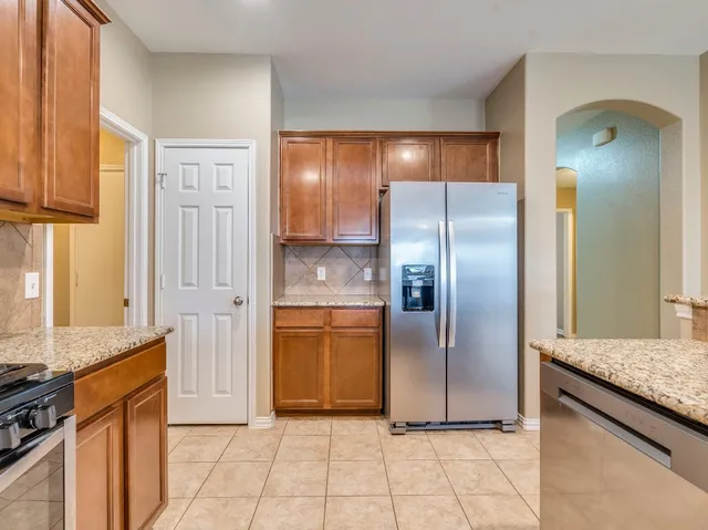 a view of an empty room with a fireplace and a window