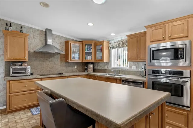 a kitchen with a stove a sink and a microwave