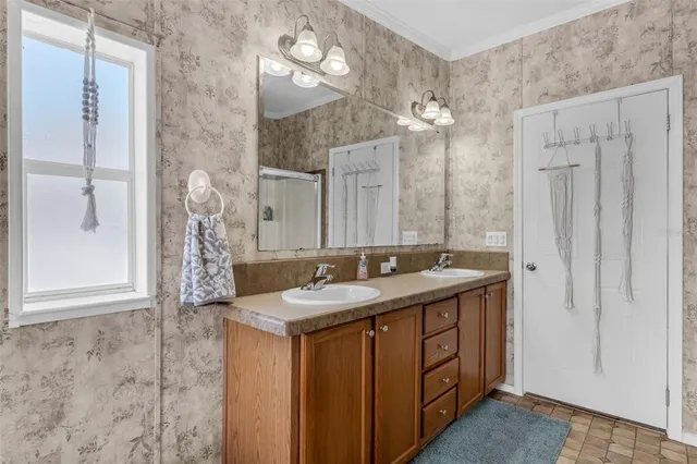 a bathroom with a sink double vanity and a mirror