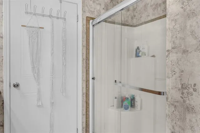 a bathroom with a shower and a shower curtain