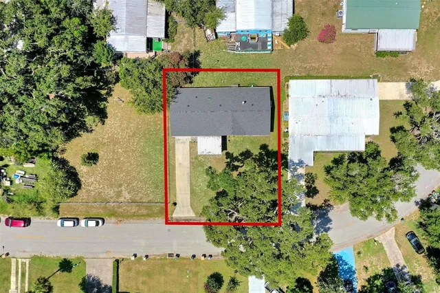 an aerial view of a house with a yard and garden