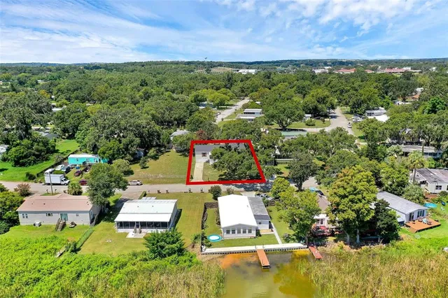a aerial view of a house with a garden and lake view