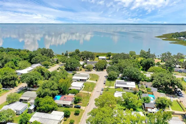 an aerial view of a house with a yard and garden