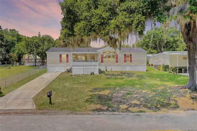 a front view of house with yard and trees