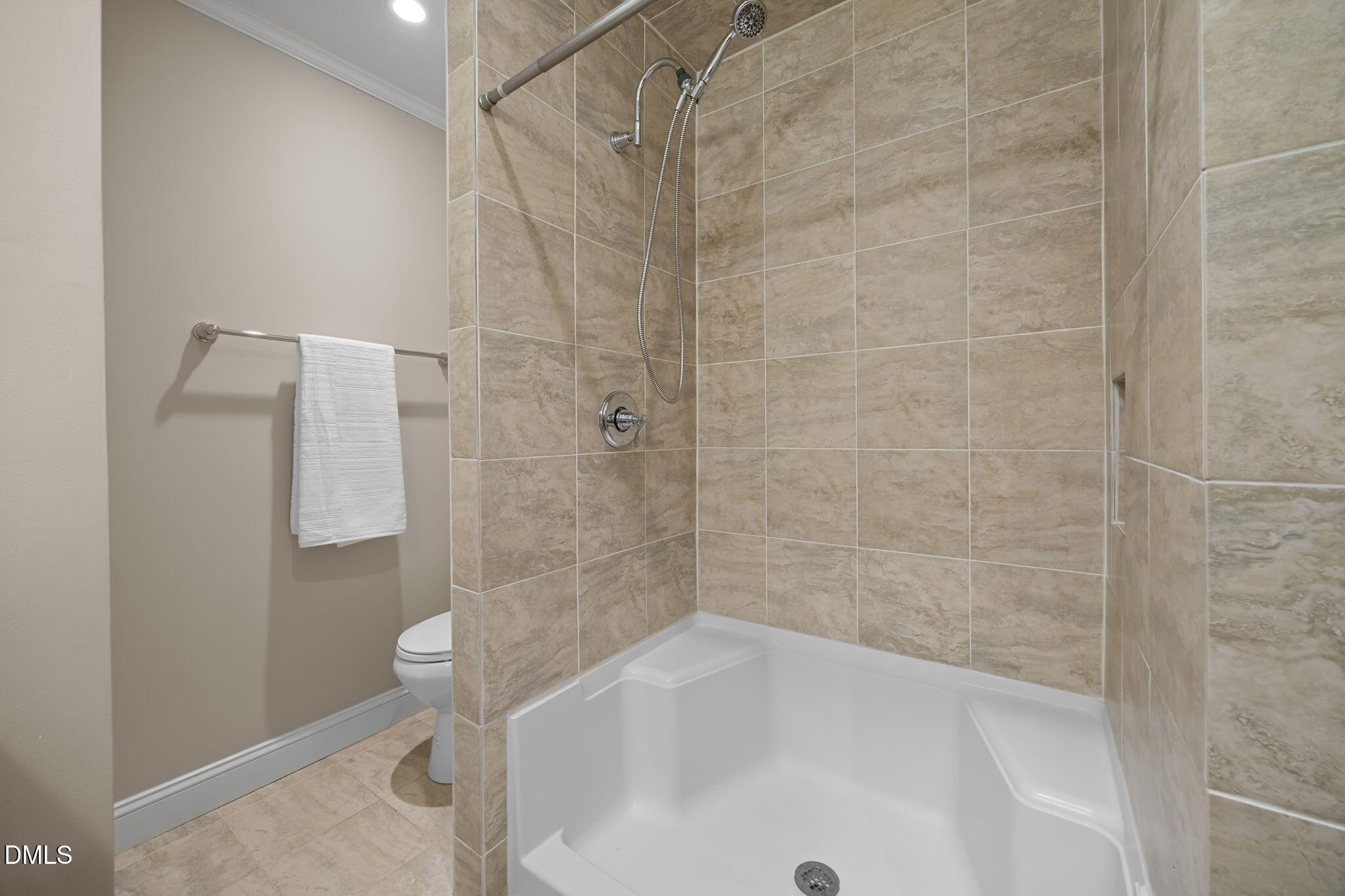 6423 New Market Way Raleigh, NC 27615 - Photo 18 of 33 a bathroom with a bathtub and a shower