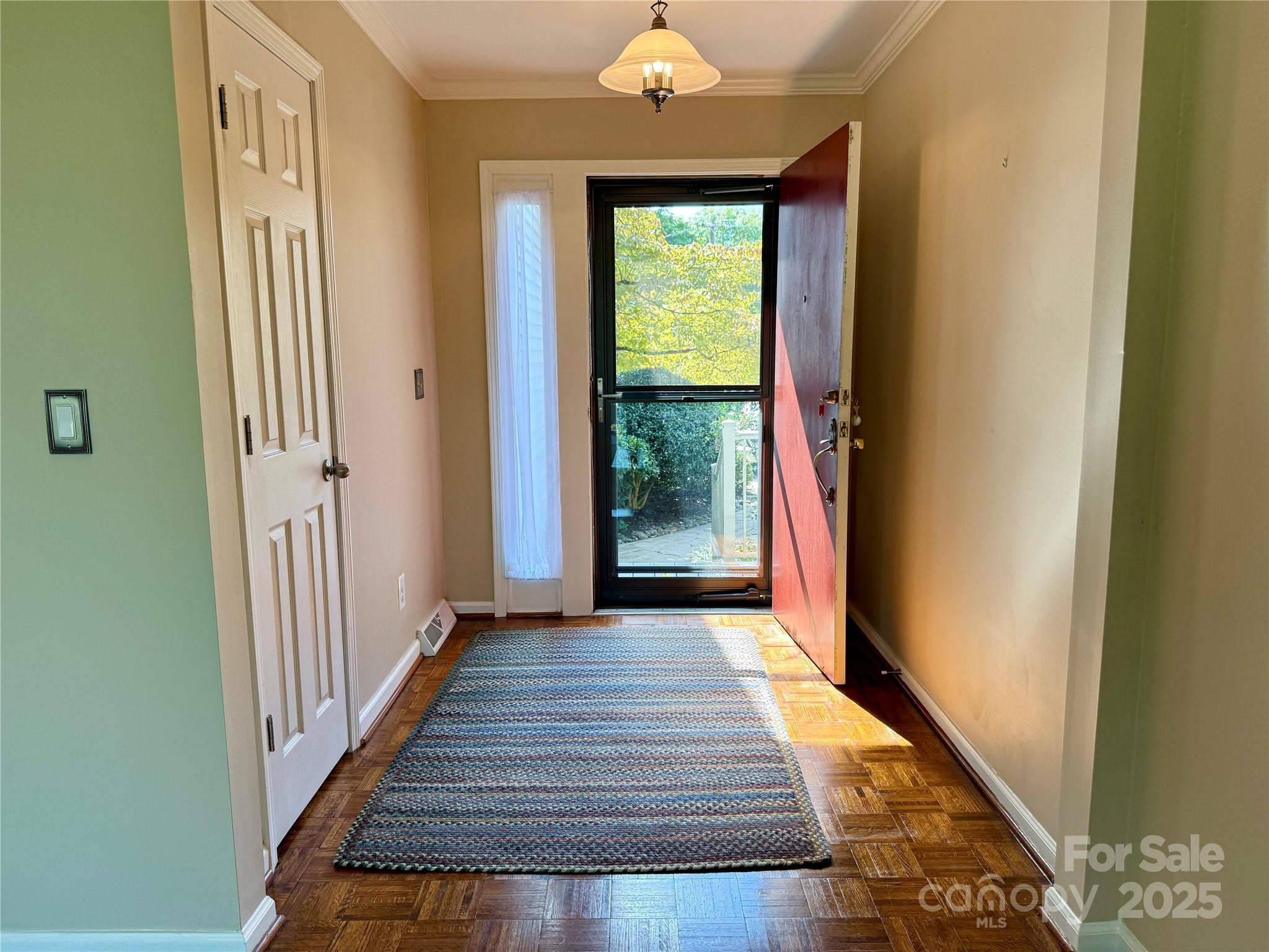 77 Chestnut Street, Unit 103 Tryon, NC 28782 - Photo 2 of 17 a view of a hallway with wooden floor and staircase