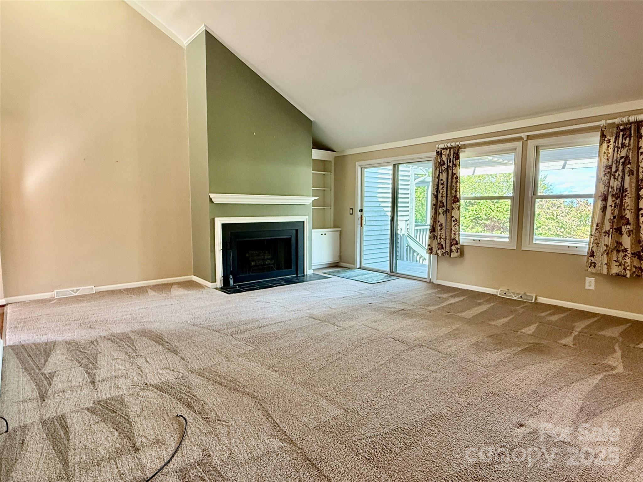 77 Chestnut Street, Unit 103 Tryon, NC 28782 - Photo 4 of 17 a view of empty room with a fireplace