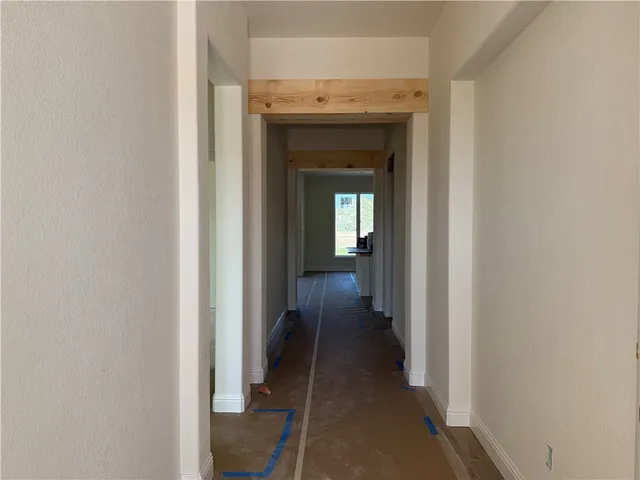 a bathroom with a granite countertop sink and white cabinets