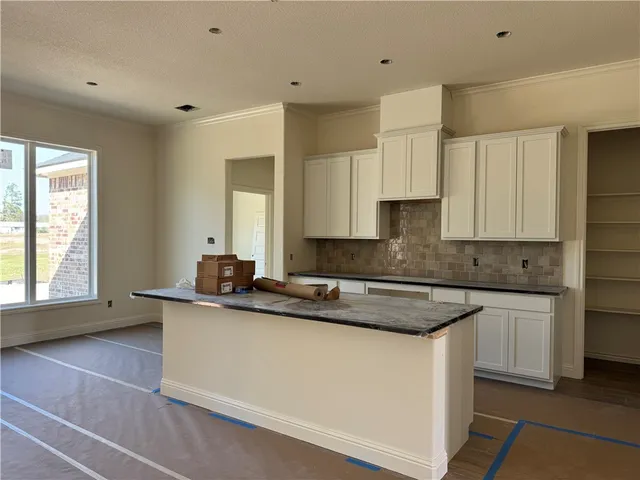 a kitchen with granite countertop cabinets stainless steel appliances and a sink